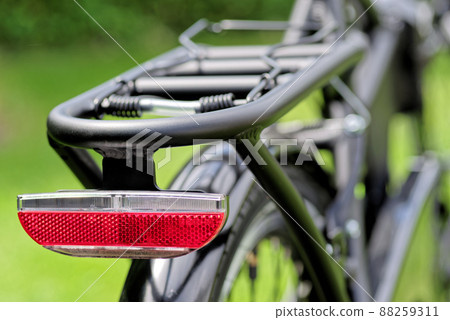 Close-up of red reflector back on a bicycle 88259311
