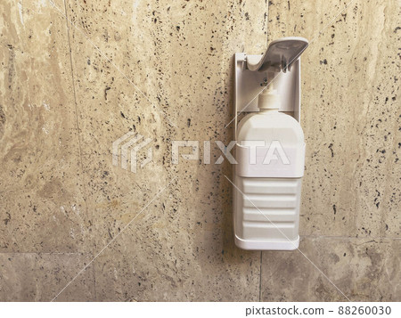Wall hand pump soap or gel dispenser. Heath and hygiene, antibacterial gel, and copy text space left side. No persons. Wall hand pump soap or gel dispenser. Heath and hygiene, antibacterial gel, and copy text space left side. No persons. 88260030