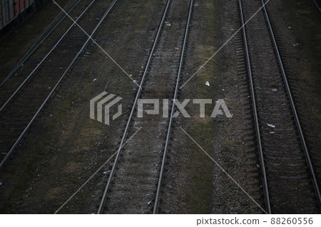 Abandoned railroad tracks. Steel rails overgrown with grass 88260556