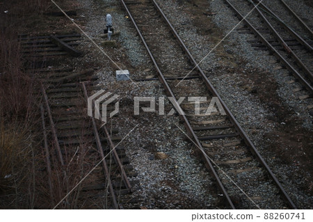 Abandoned railroad tracks. Steel rails overgrown with grass 88260741