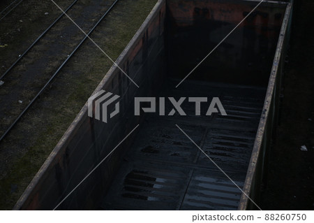 Cargo in the wagons of the train. Rail warehouse for loading materials Cargo in the wagons of the train. Rail warehouse for loading materials 88260750