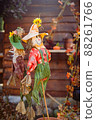 close up photo of scarecrow with sunlight pumpkin and other Halloween decorations  88261766
