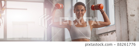 Slender lady working out in the gym 88261776