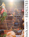 close up photo of scarecrow with sunlight pumpkin and other Halloween decorations  88261783
