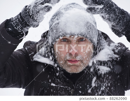 Portrait of a handsome man covered in snow. 88262090