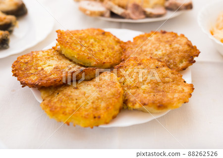 Potato pancakes with sour cream on white plate 88262526