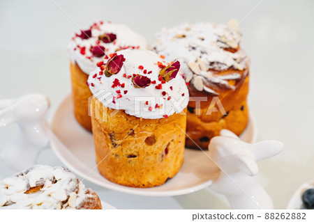 decorated panettones and cruffins on serving plate with rabbits. easter cakes. decorated panettones and cruffins on serving plate with rabbits. easter cakes. 88262882