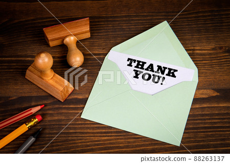Thank You. Written text Inside An Envelope Letter. Wood texture background Thank You. Written text Inside An Envelope Letter. Wood texture background 88263137
