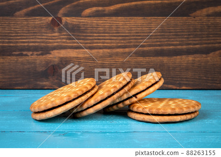 Cookies stacked with chocolate filling. Holidays and celebrations. Wooden background 88263155