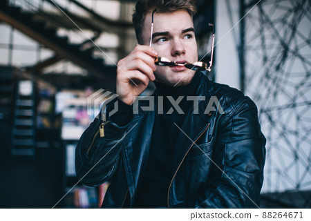 Brutal young man with sunglasses in contemporary cafe 88264671