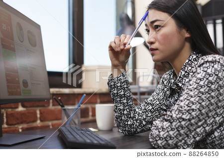 Meditating financial advisor reviewing accounting report received by email from business manager. Advertising company office worker analyzing management chart sent by executive board. 88264850