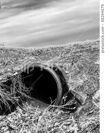 HDPE drainage culvert under a road entrance. Pipe is used to convey stormwater between ditches. 88264879