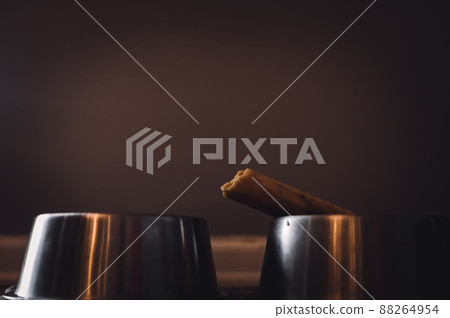 Side view of a dog chew bone with a metal bowl 88264954