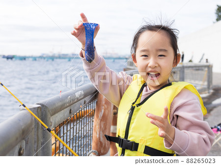 Girl enjoying fishing 88265023