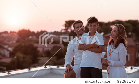 Happy family enjoys and spends time together on the roof of the house. Selective focus  88265178