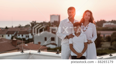 Happy family enjoys and spends time together on the roof of the house. Selective focus  88265179