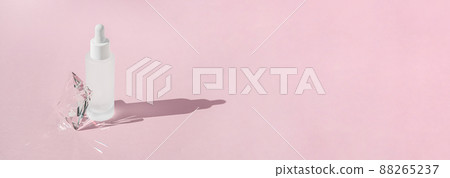 Serum skincare product with collagen and peptide in white bottle with dropper on pink backdrop with crystal glass prism refracting light effects and rays of light. Product mockup packaging 88265237