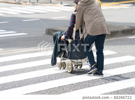 Elderly people in wheelchairs and care workers 88266722