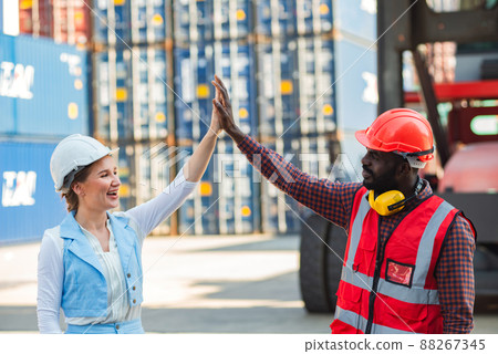 Happy giving hands two businesswoman and engineer working checking loading Containers box from Cargo freight ship for import export. shipping in docks. Happy giving hands two businesswoman and engineer working checking loading Containers box from Cargo freight ship for import export. shipping in docks. 88267345