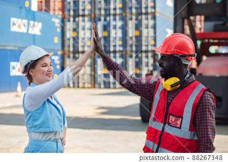 Happy giving hands two businesswoman and engineer working checking loading Containers box from Cargo freight ship for import export. shipping in docks. Happy giving hands two businesswoman and engineer working checking loading Containers box from Cargo freight ship for import export. shipping in docks. 88267348
