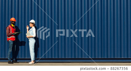 Businesswoman and engineer talking and checking loading Containers box from Cargo freight ship for import export. shipping in docks. Businesswoman and engineer talking and checking loading Containers box from Cargo freight ship for import export. shipping in docks. 88267356