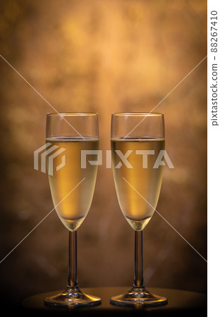 Champagne glasses over holiday bokeh blinking background, glasses with sparkling wine, celebration 88267410