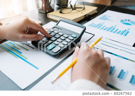 Close up a Woman working about financial with calculator at her home to calculate expenses, Accounting concept Close up a Woman working about financial with calculator at her home to calculate expenses, Accounting concept 88267562