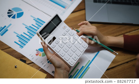 Close up of bookkeeper or financial inspector hands making report, calculating or checking balance. 88267717