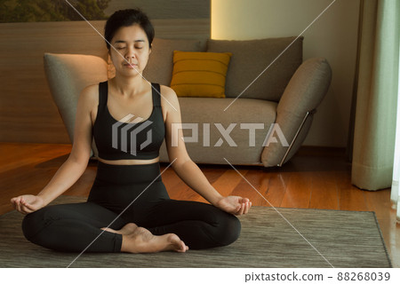 Woman doing yoga exercise on bed at home. Morning workout in bedroom. Healthy and sport lifestyle. 88268039