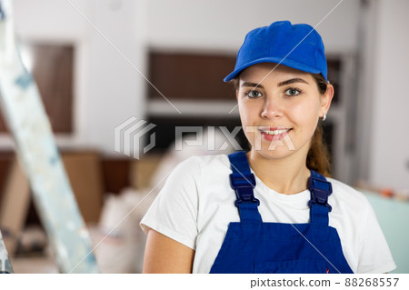 Smiling woman repairer standing inside apartment Smiling woman repairer standing inside apartment 88268557