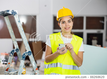 Smiling female architect using smartphone at construction site Smiling female architect using smartphone at construction site 88268620