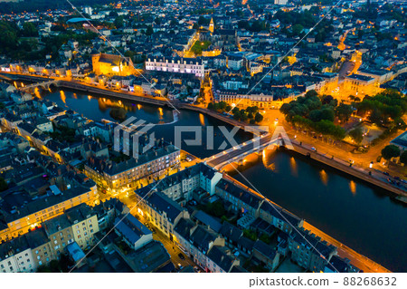 Evening aerial view of Laval with buildings, river Mayenne and old bridge 88268632