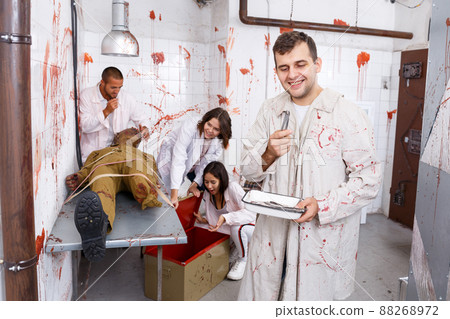 Cheerful guy in quest room with bloody traces Cheerful guy in quest room with bloody traces 88268972