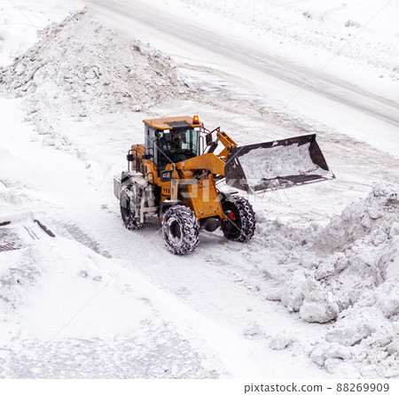 Cleaning and cleaning of roads in the city from snow in winter Cleaning and cleaning of roads in the city from snow in winter 88269909
