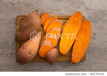 Whole and cut raw orange sweet potato 88270314