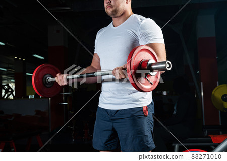 Male athlete lifts the barbell Male athlete lifts the barbell 88271010
