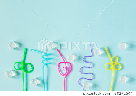 Creative summer background composition with colorful cocktail straws and ice cubes. 88271544
