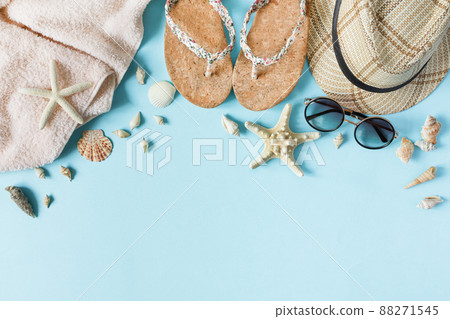Beach accessories on pastel blue background top view. Summer background. 88271545