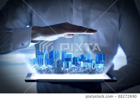 Holographic image of urban development that emerges from the tablet 88272690