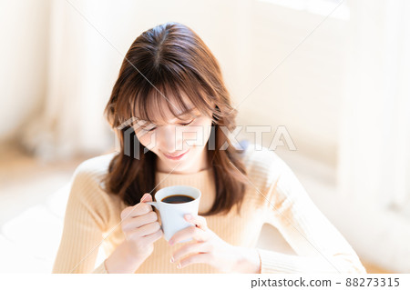 A woman relaxing with coffee A woman relaxing with coffee 88273315