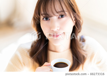 A woman relaxing with coffee A woman relaxing with coffee 88273316