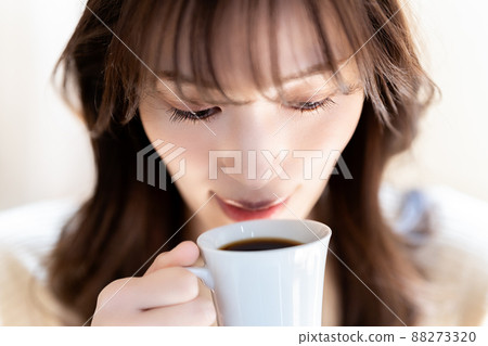 A woman relaxing with coffee A woman relaxing with coffee 88273320