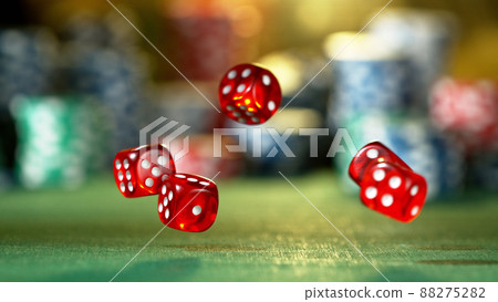Red dice rotating in the air, poker chips on background. 88275282