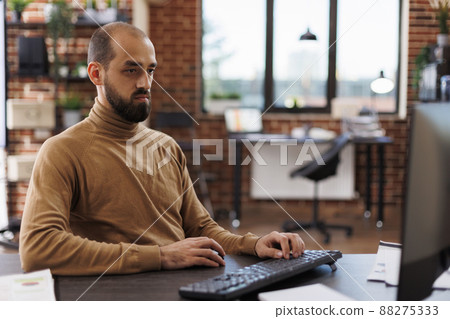 Fintech company office worker brainstorming business investment ideas and project management chart. Executive assistant developing accounting financial documentation while at desk in workspace. Fintech company office worker brainstorming business investment ideas and project management chart. Executive assistant developing accounting financial documentation while at desk in workspace. 88275333