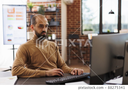 Research agency employee reviewing financial solutions while in office workspace. Business company office person developing investment ideas and startup project management plan. Research agency employee reviewing financial solutions while in office workspace. Business company office person developing investment ideas and startup project management plan. 88275341