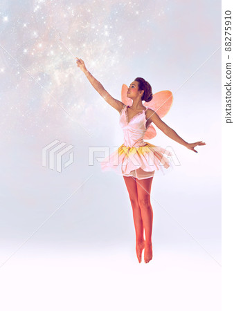 Bringing the magic. A full length shot of a cute fairy casting a spell. 88275910