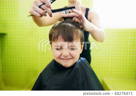 His first haircut. Cropped shot of a young boy getting his first haircut. 88276871