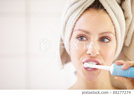Keeping her teeth in great shape - Dental hygiene. Cropped shot of an attractive young woman brushing her teeth. 88277274