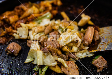 Stir-fried chicken ribs with chicken, cabbage, vegetables, spicy seasoning, and tteokbokki, traditional Korean food Stir-fried chicken ribs with chicken, cabbage, vegetables, spicy seasoning, and tteokbokki, traditional Korean food 88277413