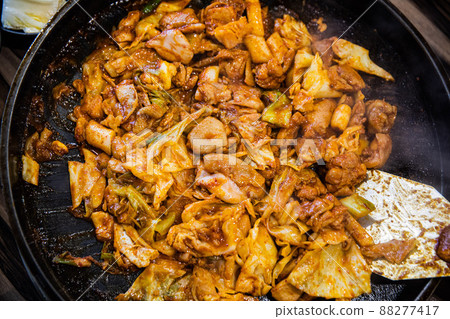 Stir-fried chicken ribs with chicken, cabbage, vegetables, spicy seasoning, and tteokbokki, traditional Korean food Stir-fried chicken ribs with chicken, cabbage, vegetables, spicy seasoning, and tteokbokki, traditional Korean food 88277417
